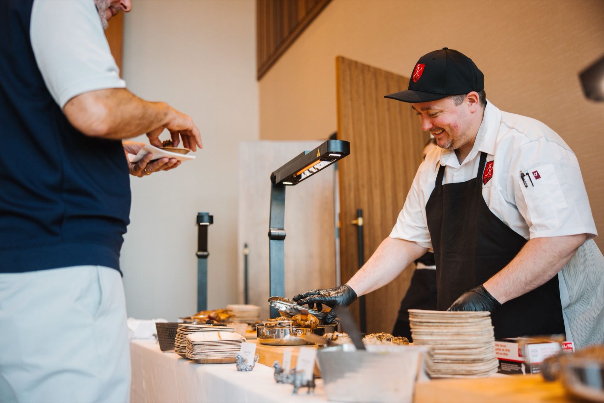 A Greenleaf chef serving a guest at a carving station